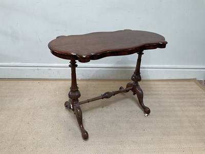 Lot 1074 - A Victorian walnut centre table of shaped...
