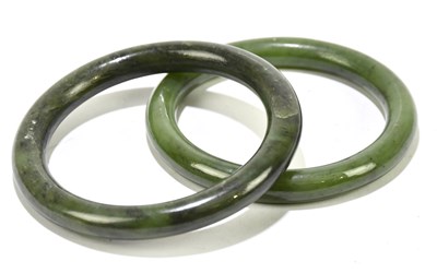 Lot 1282 - Two jade bangles, one diameter 8cm, the other...