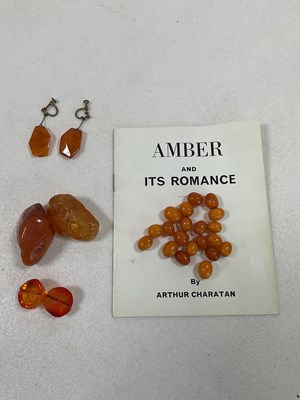 Lot 450 - A group of loose amber beads, two large rough...