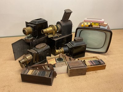 Lot 5 - Four magic lanterns in metal cases with a box...