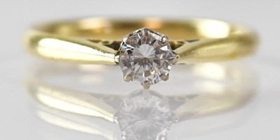 Lot 991 - An 18ct yellow gold solitaire ring set with a...