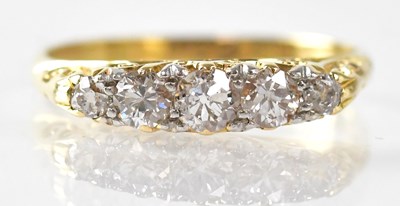 Lot 999 - An 18ct yellow gold ring set with five...