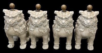 Lot 1033 - A group of four modern plaster Dogs of Fo,...