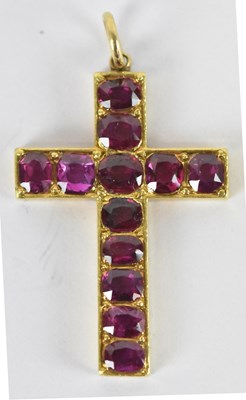 Lot 1256 - A yellow metal ruby set crucifix pendant set...