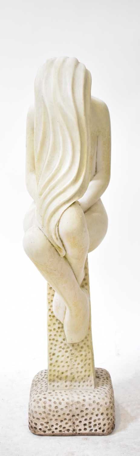 Lot 75 - A garden statue modelled as a woman sitting on...