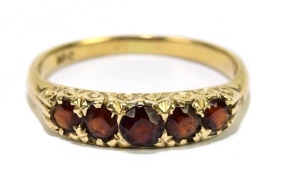 Lot 1160 - A yellow metal five stone garnet ring stamped '...
