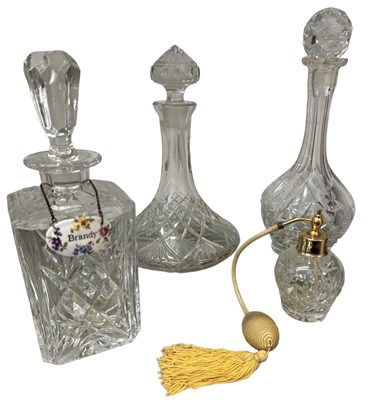 Lot 668 - A group of three crystal glass decanters, one...