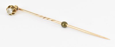 Lot 1350 - A yellow metal diamond set pin, length 6cm,...