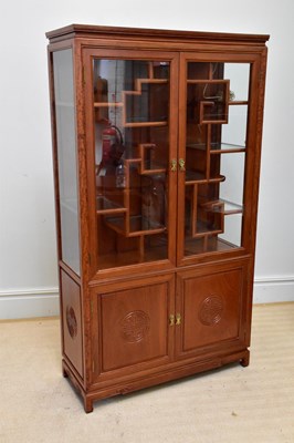 Lot 1045 - A Chinese rosewood display cabinet, with twin...