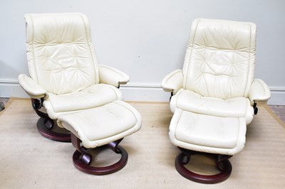 Lot 1041 - STRESSLESS; a pair of cream leather armchairs...