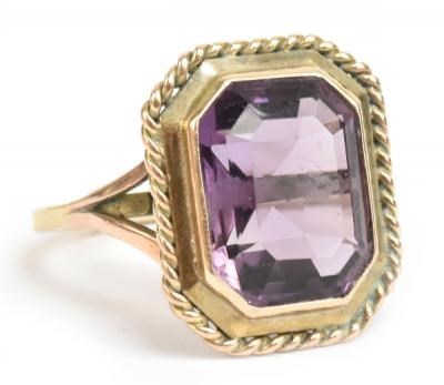 Lot 184 - A yellow metal and amethyst dress ring, the...