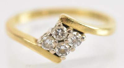 Lot 1287 - An 18ct yellow gold diamond ring set with four...