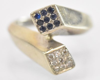 Lot 1248 - An 18ct white gold diamond and sapphire...