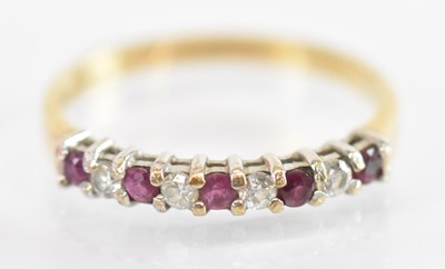 Lot 1321 - A 9ct yellow gold red and white stone set ring,...