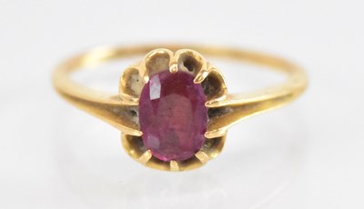 Lot 1289 - A yellow metal ruby set ring, the central ruby...