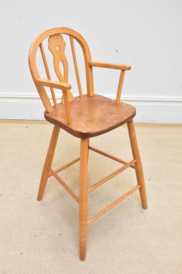 Lot 1149 - An Ercol style child's high chair, height 82cm.