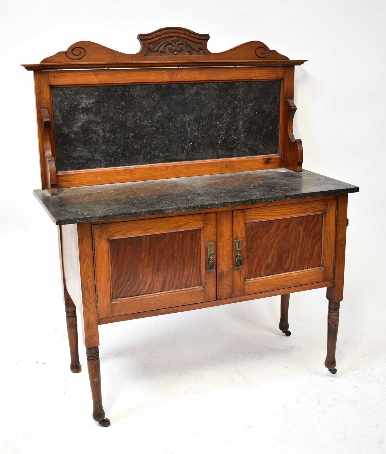Lot 36 - An Edwardian oak marble-topped wash stand with...