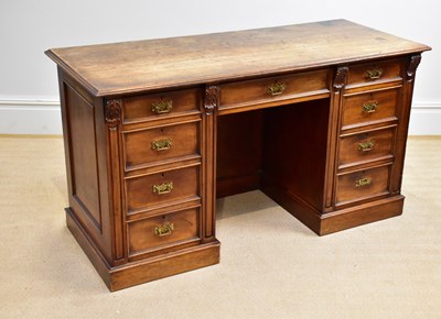 Lot 1186 - A late Victorian kneehole desk with an...