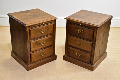 Lot 1084 - A pair of reproduction oak bedside chests with...