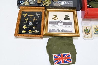 Lot 398 - A collection of military badges and buttons to...