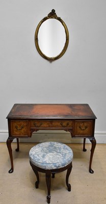 Lot 1190 - A walnut three drawer kneehole desk with...