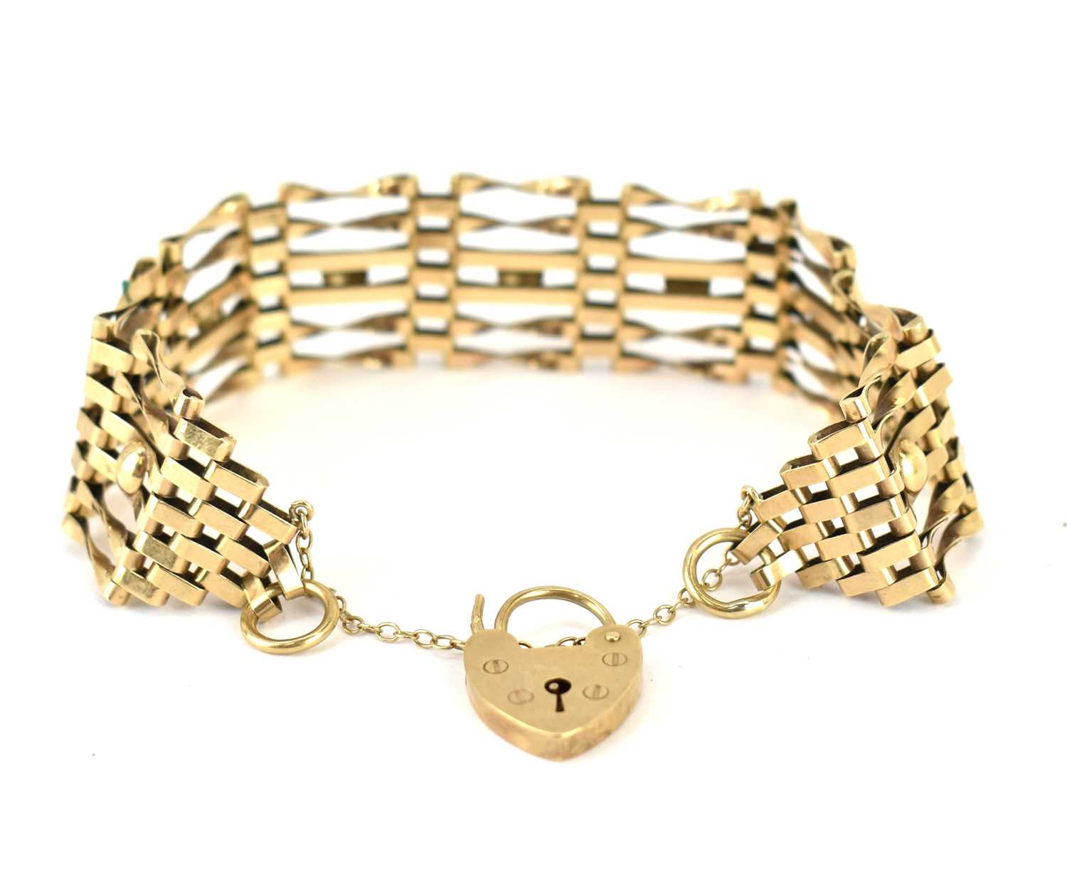 Lot 1046 - A 9ct gold six-bar gate bracelet with safety...