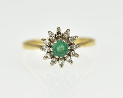 Lot 1009 - An 18ct gold emerald and diamond set ring, the...