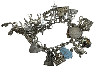 Lot 1392 - A hallmarked silver charm bracelet, with...