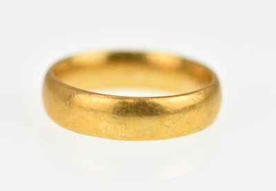 Lot 985 - A 22ct gold wedding band, size O, approx. 7.2g.