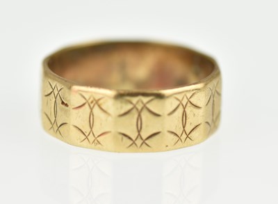 Lot 1017 - A 9ct gold band ring with faceted sides and...