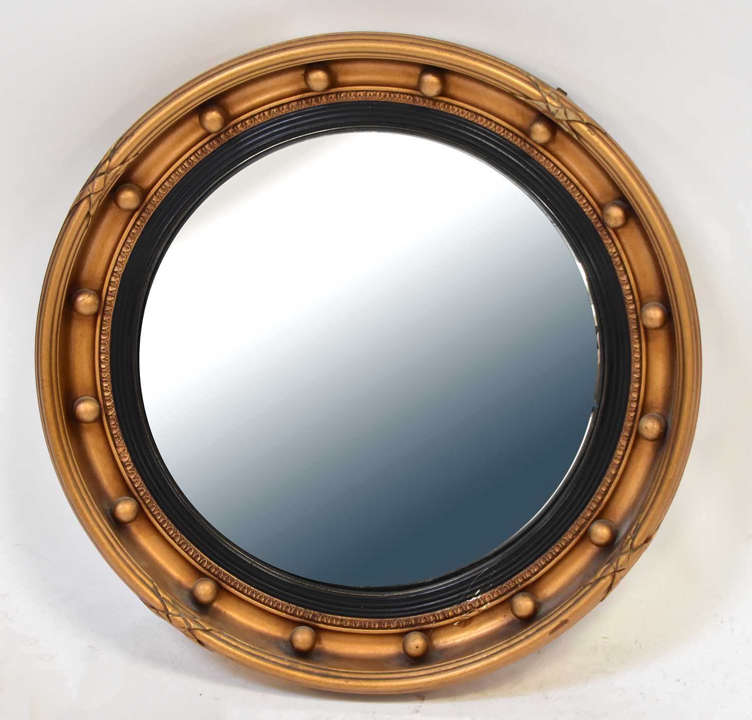 Lot 68 - A gilt framed convex wall mirror with beaded...