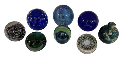 Lot 675 - A group of eight art glass paperweights...