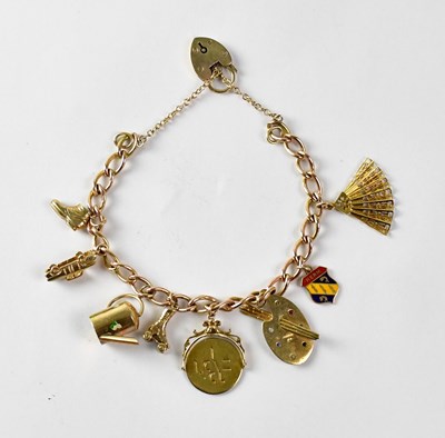 Lot 1041 - A 9ct yellow gold charm bracelet suspending...