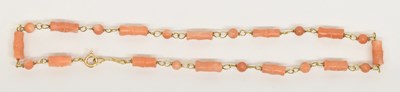 Lot 1294 - A 9ct yellow gold and bamboo effect coral...