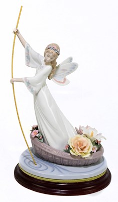 Lot 496 - LLADRO; a ceramic figure of an angel on a...