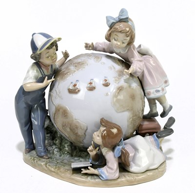 Lot 497 - LLADRO; a figure group of children around a...