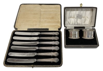 Lot 1206 - A cased pair of hallmarked silver napkin rings,...