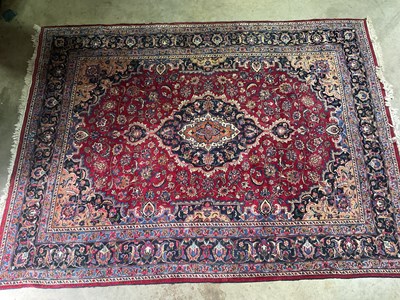 Lot 692 - A Persian rug with a single blue medallion and...