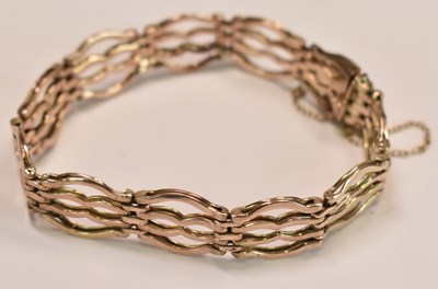 Lot 602 - A 9ct yellow gold four bar gate link bracelet,...