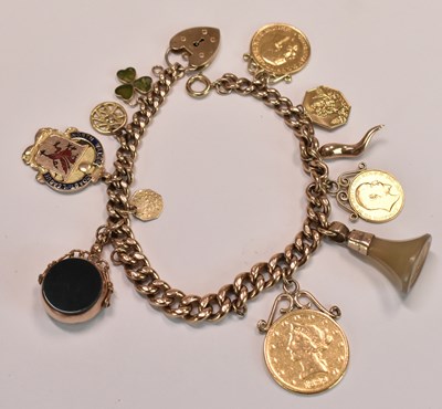 Lot 579 - A 9ct yellow gold charm bracelet suspending...