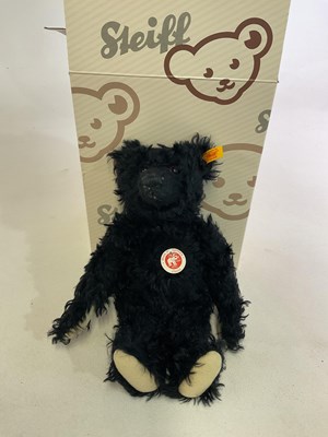 Lot 241 - STEIFF; a black teddy bear with cream felted...