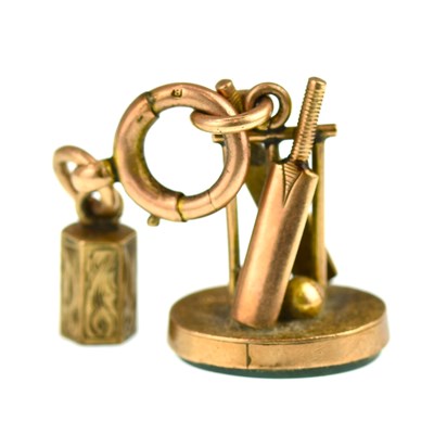 Lot 1111 - A 9ct rose gold cricket theme seal fob with...