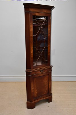 Lot 1085 - A reproduction mahogany freestanding corner...