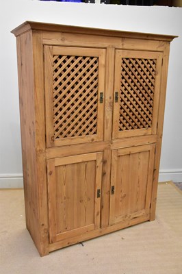 Lot 1174 - A Continental pine cupboard with two pairs of...