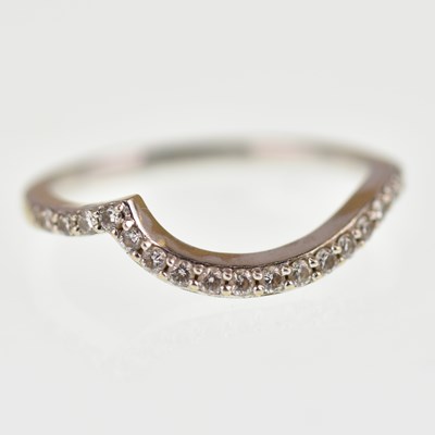 Lot 989 - An 18ct white gold contemporary wedding band,...
