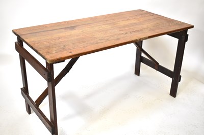 Lot 65 - A vintage oak folding trestle table of plank...