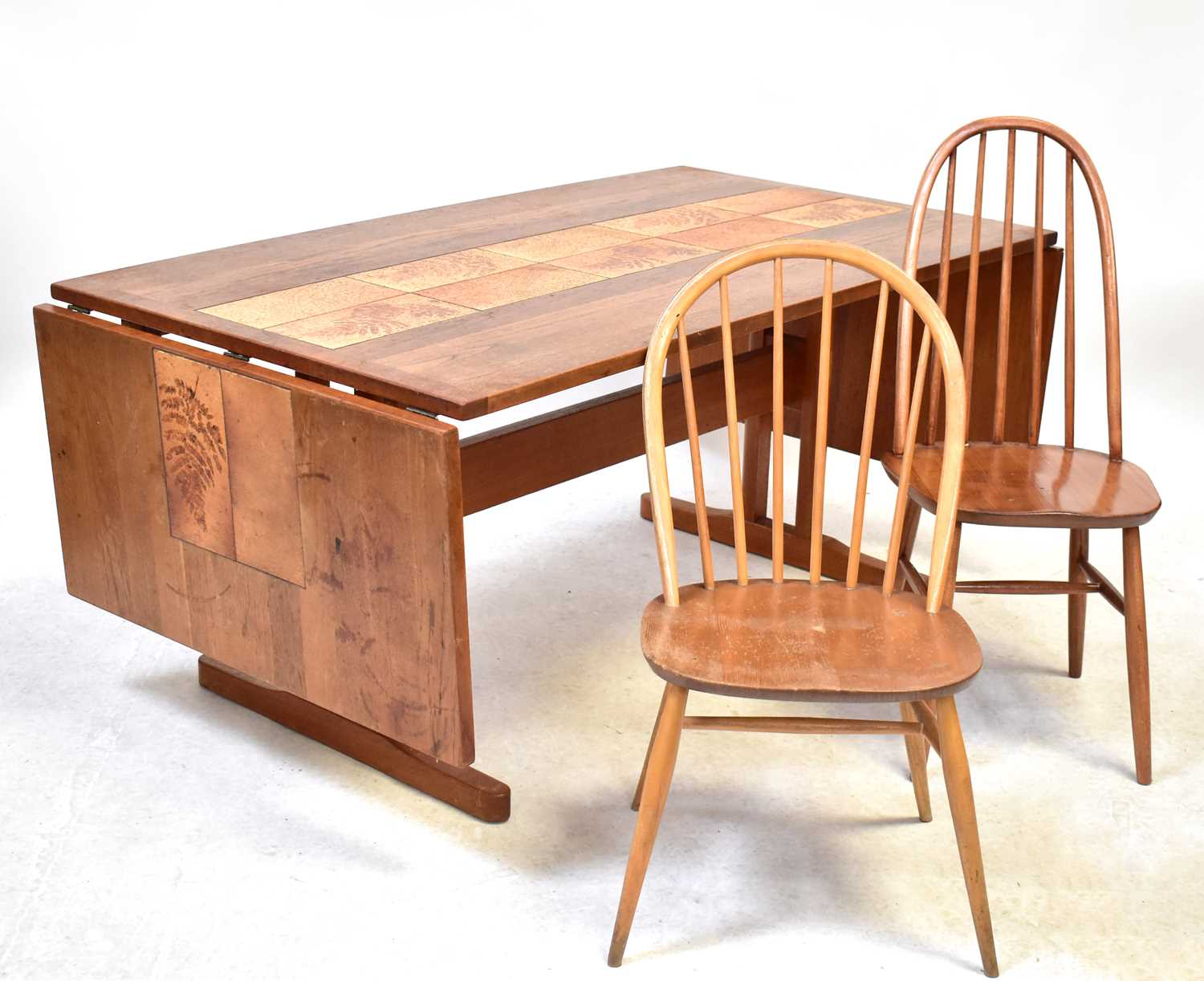 Lot 4 - A mid-20th century elm drop-leaf dining table...