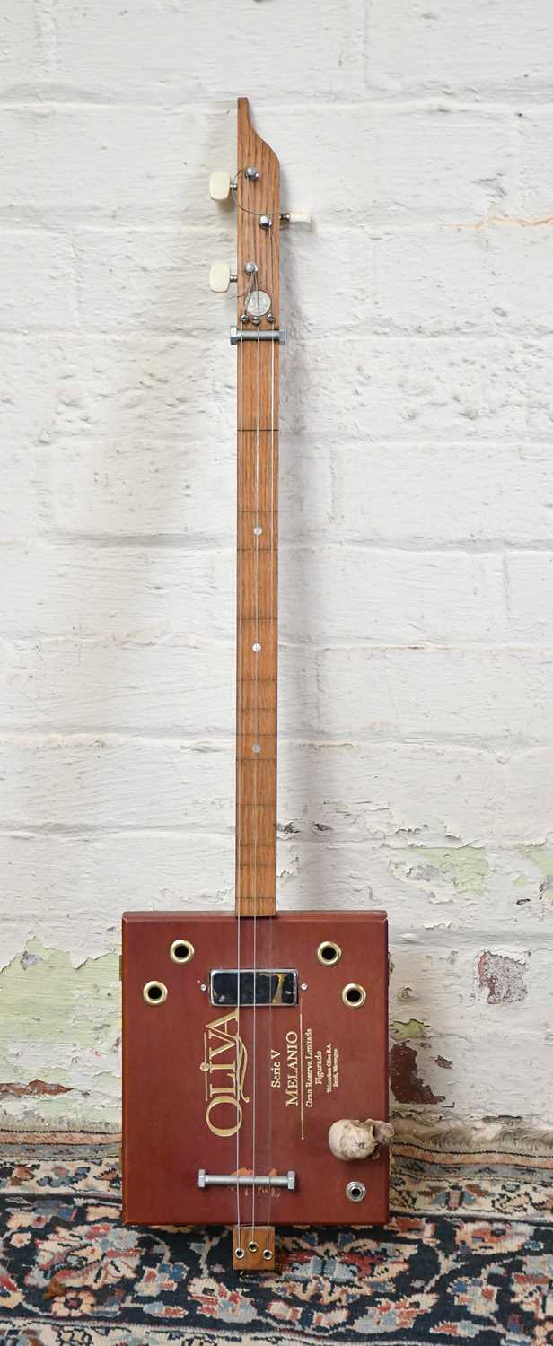 Lot 1584 - A scratch built three string cigar box guitar.