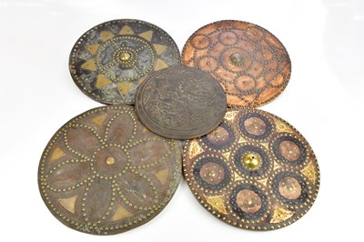 Lot 1249 - Four replica leather mounted circular shields,...