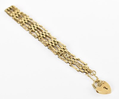 Lot 1308 - A 9ct yellow gold gate link bracelet, with 9ct...